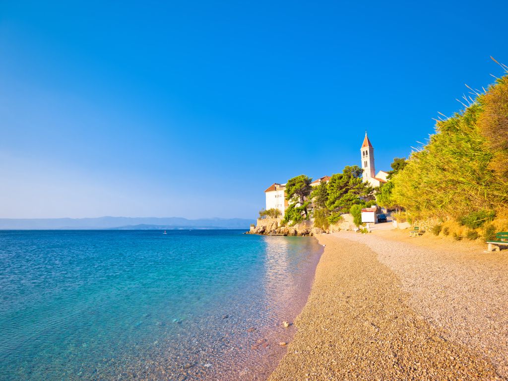 Monastery on pebble beach in Bol island of Brač, Dalmatia, Croatia